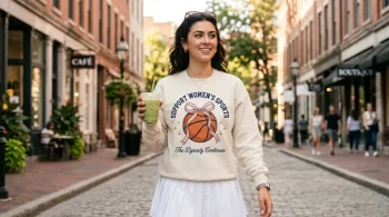 USA women's basketball 8-peat inspired coquette embroidered sweatshirt worn by a stylish woman in the city.