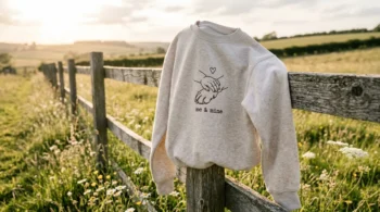 Millie Bobby Brown inspired custom pet and baby line-art sweatshirt on a rustic fence.