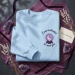 Enchanted Lyrics Embroidered Sweatshirt - Mystical Crystal Ball Design, Light Blue embroidered-sweatshirt